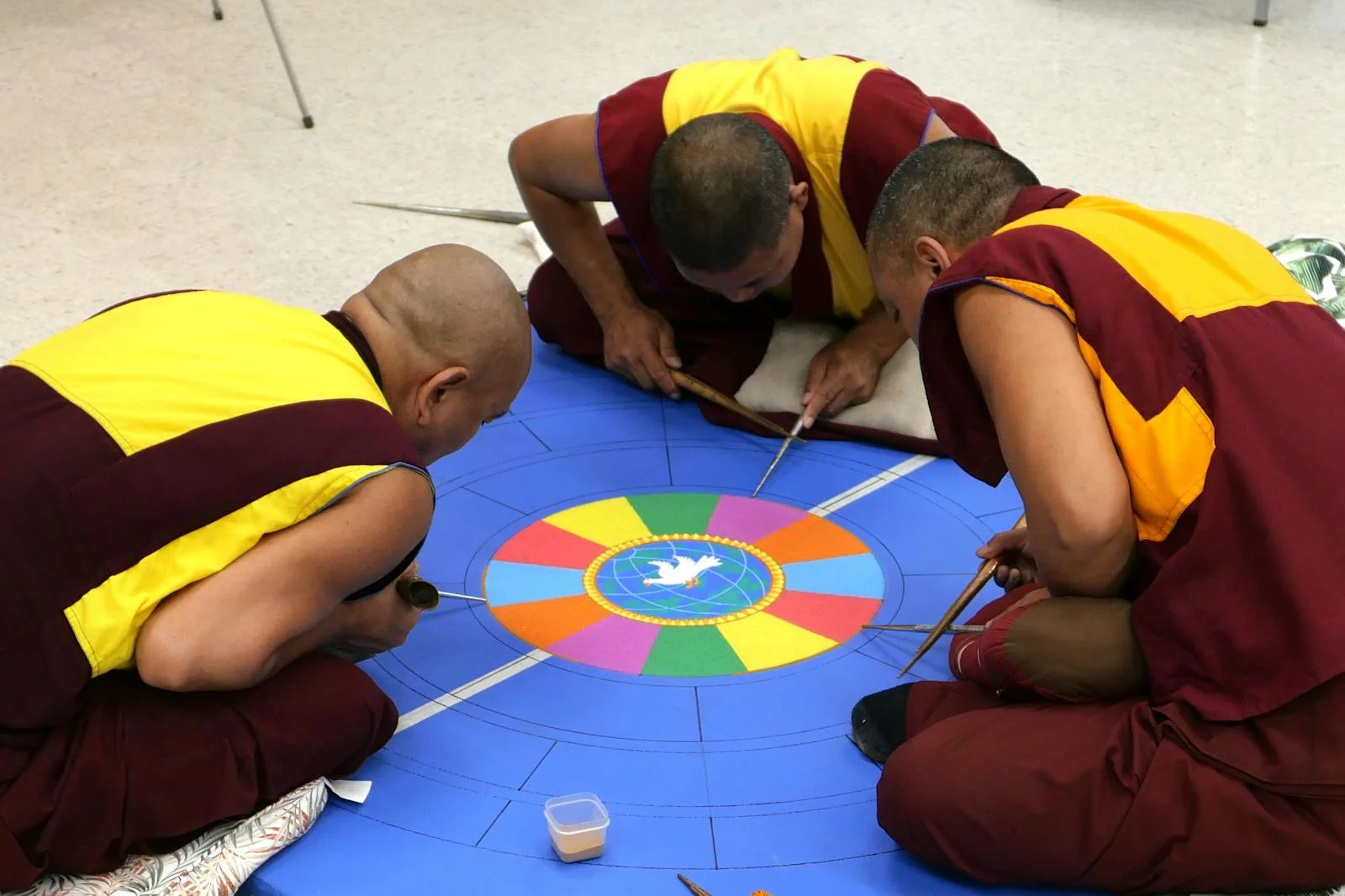 Tibetan Sand Mandala - Tibetan monks intricately craft a vibrant sand mandala at a ceremony in Lecanto, Florida.